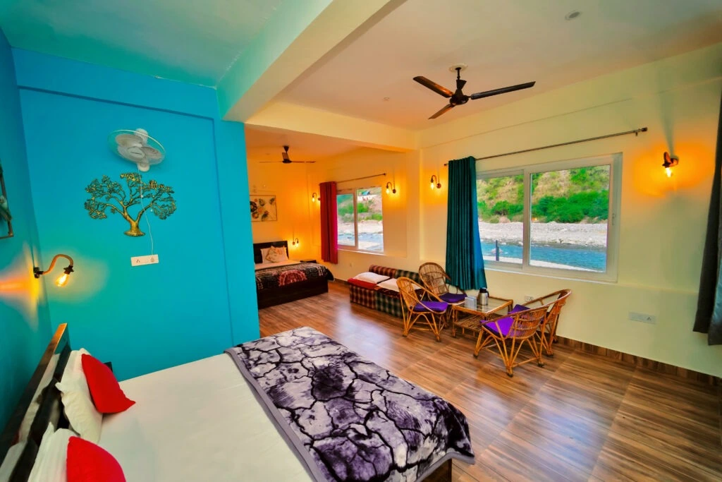 Spacious family room with seating area and river view at RS04 resort