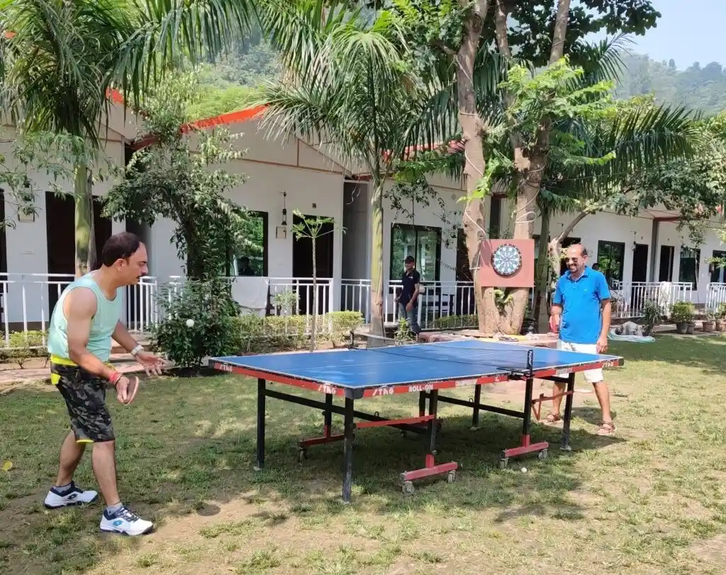Guests playing table tennis in garden area at RS04 resort in Rishikesh
