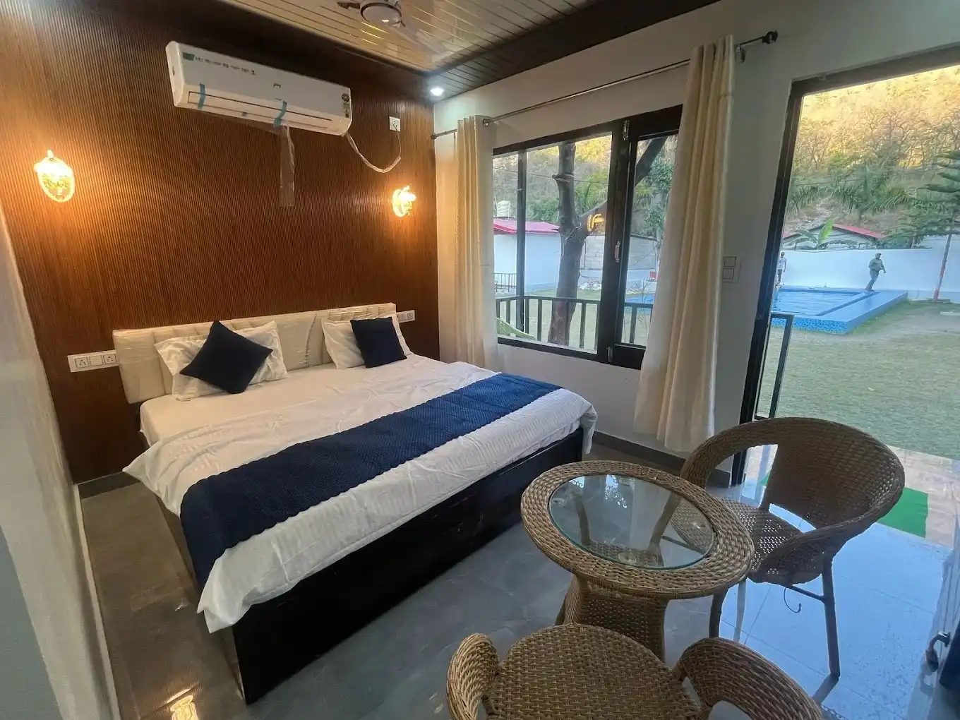 Modern AC room with balcony seating and garden view at RS05 resort