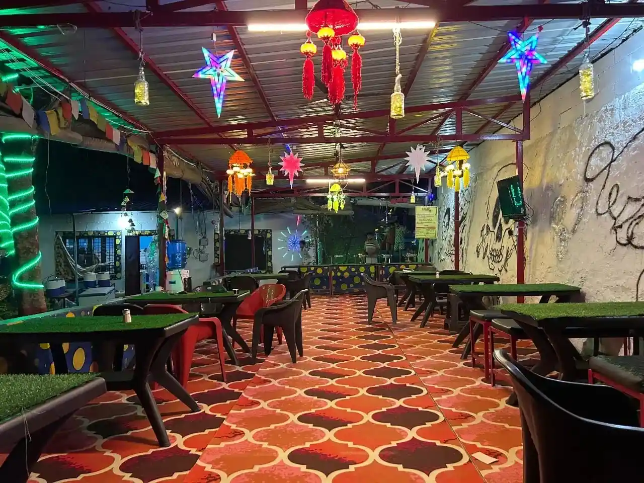 Decorated camp dining area with colorful lights and seating at RS06 riverside camps
