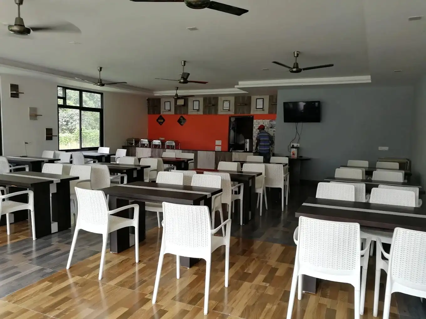 Spacious indoor restaurant and dining hall with buffet setup at resort