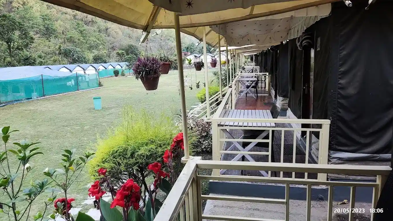 Luxury Swiss tent corridor with private sit-out and lawn view in Rishikesh