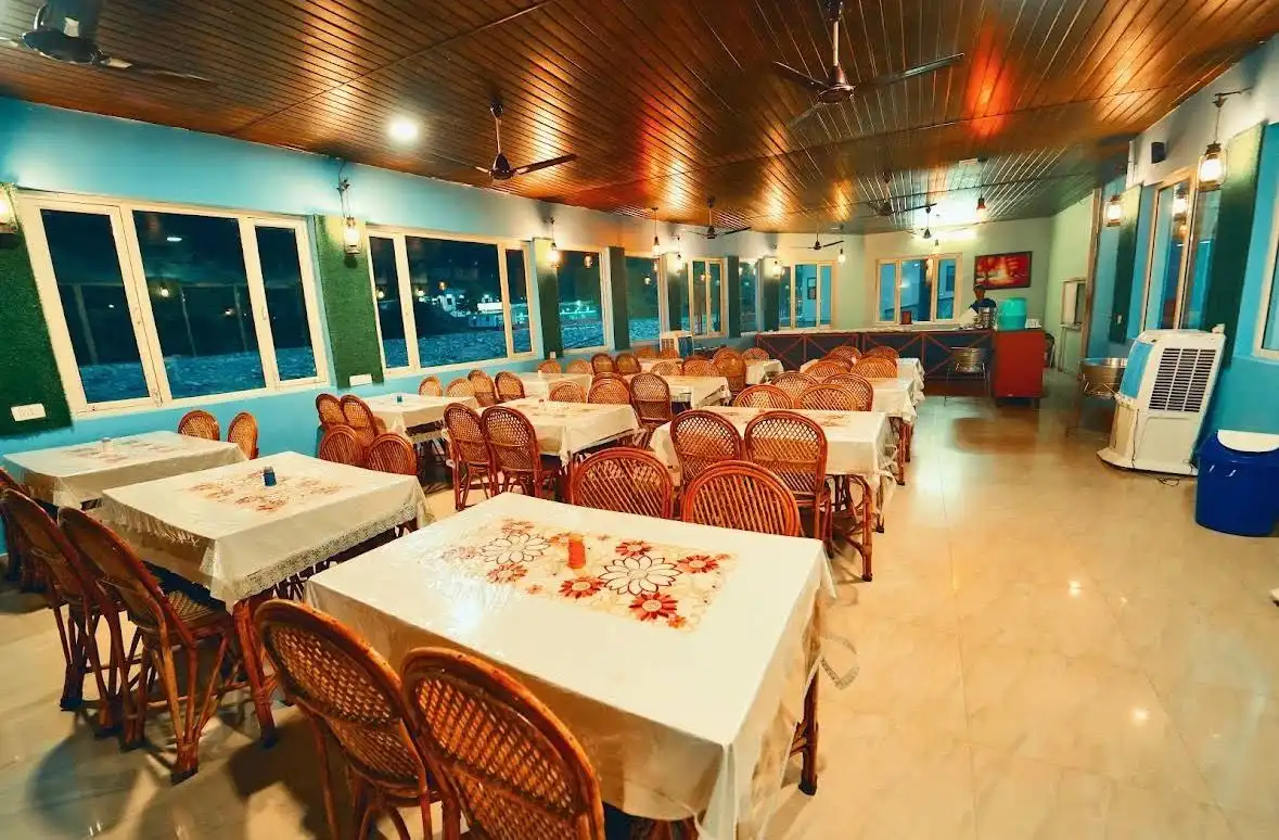 Spacious indoor dining hall with seating and warm lighting at RS08 resort