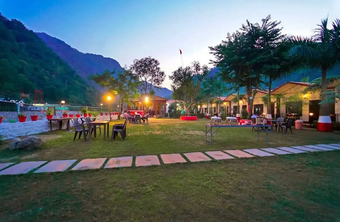 Evening lawn seating area with cottages and mountain views at RS08 resort