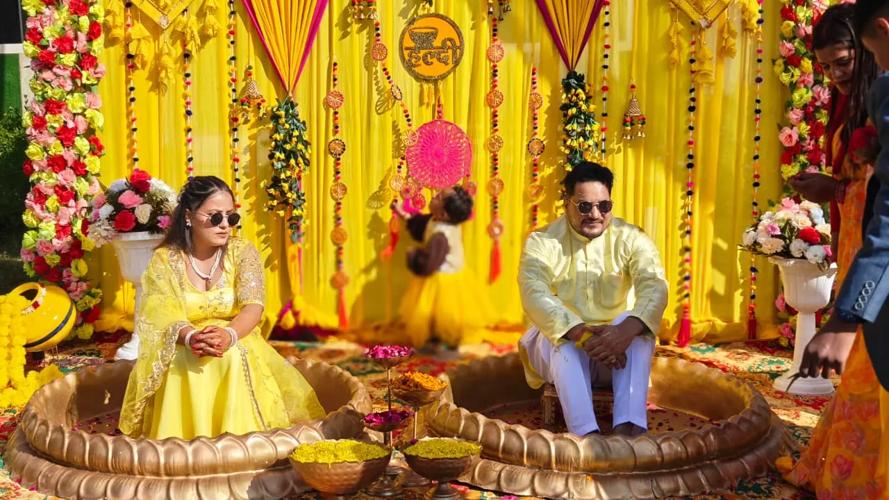 Couple enjoying haldi ceremony at RS01 resort in Rishikesh with traditional yellow décor
