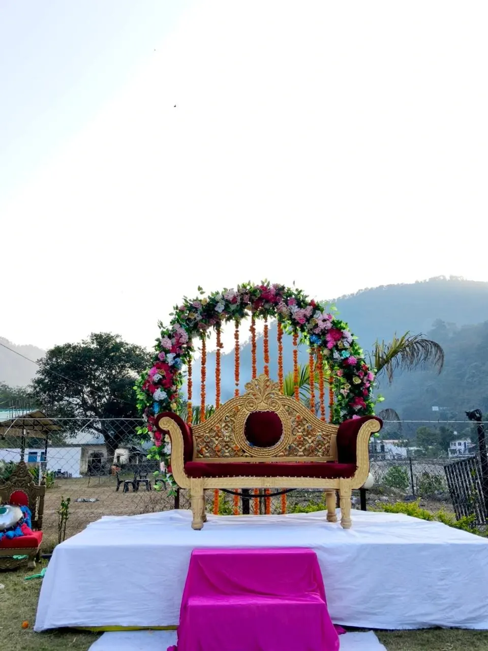 Floral wedding stage with royal sofa at RS03 resort in Rishikesh for destination wedding ceremonies