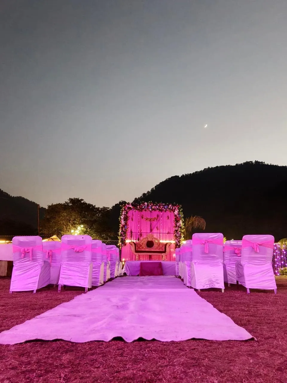 Night destination wedding setup at RS03 resort in Rishikesh with decorated stage and guest seating