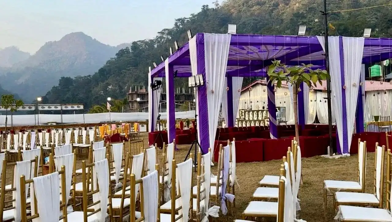 Wedding ceremony seating arrangement in Rishikesh with elegant chairs and covered mandap in hill station venue