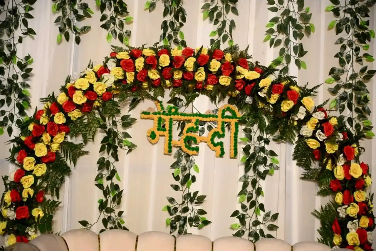Floral mehendi backdrop decoration for destination wedding in Rishikesh with roses and greenery design