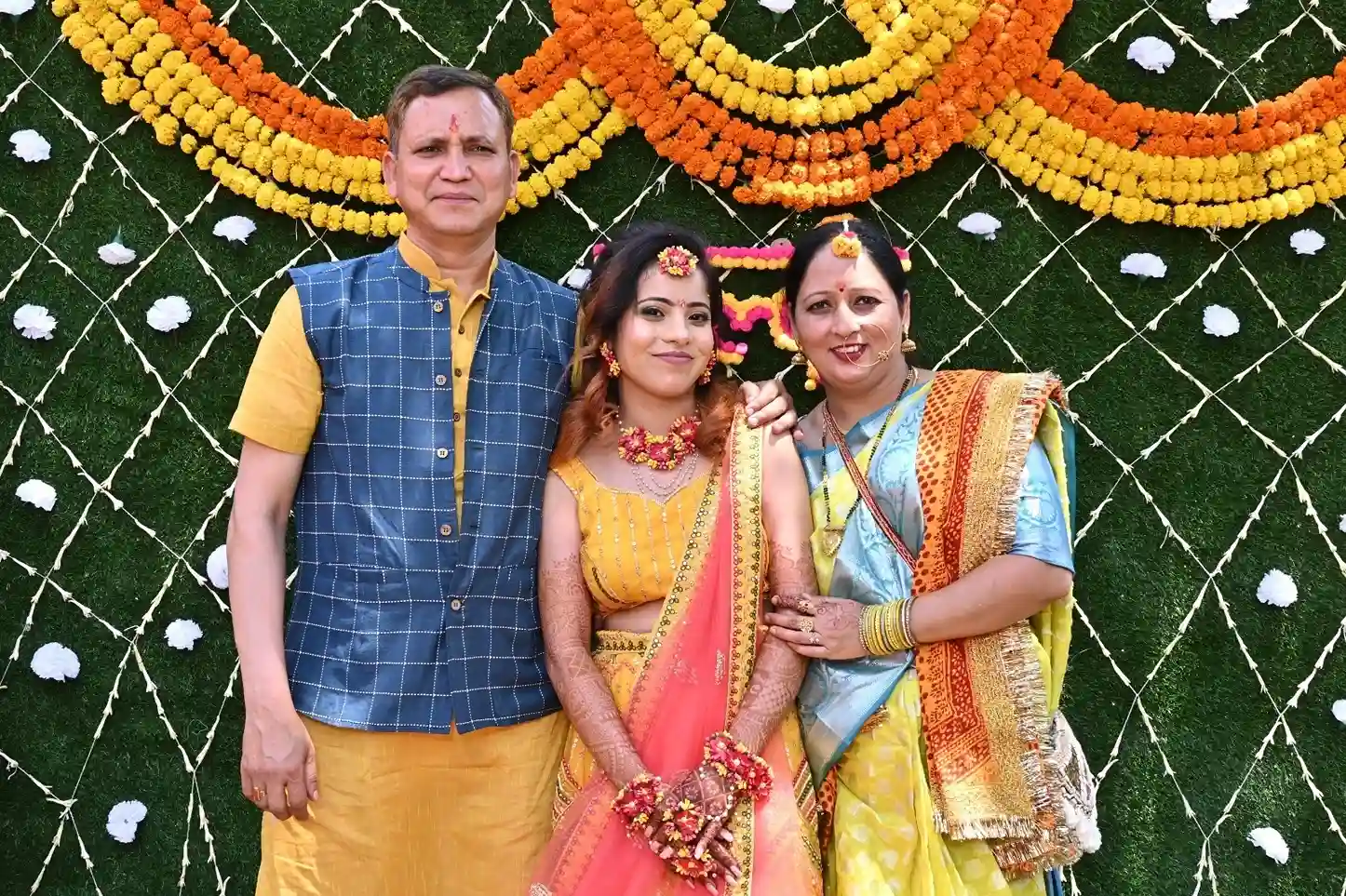 Haldi ceremony family portrait at RS08 resort in Rishikesh with floral marigold backdrop and traditional decor