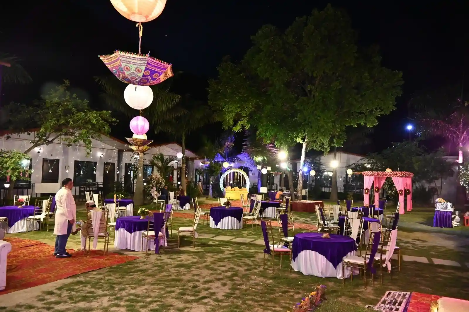 Evening destination wedding lawn setup at RS08 resort in Rishikesh with decorative lights, banquet seating and garden ambience