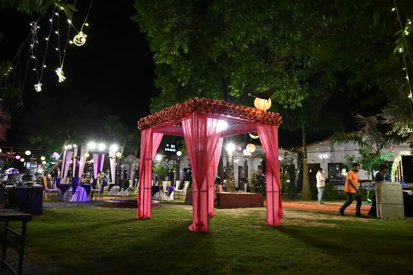 Evening wedding stage setup with floral backdrop at RS08 resort