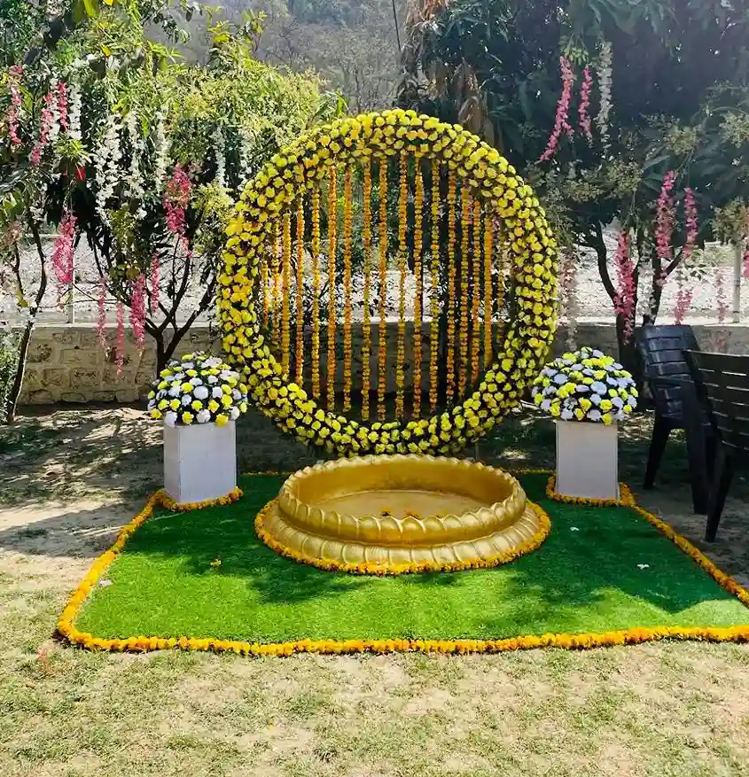 Haldi ceremony seating decor at RS08 resort in Rishikesh with floral ring backdrop and mountain view